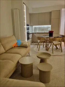 Living room with sofa and dining area in an open-plan space. - image 3