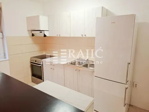Smaller kitchen with white cabinets, stove, and refrigerator. - image 6
