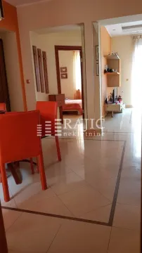 Living room with dining area and a view of the hallway. - image 8
