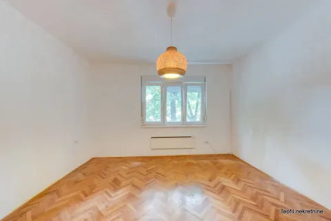 Empty room with white walls, wooden parquet flooring, and a pendant lamp. - image 9