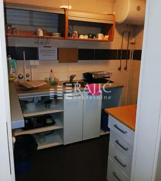 Small kitchen with open shelving and basic elements. - image 5