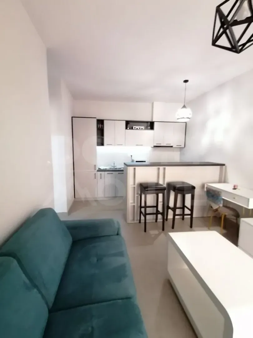 Living room with a sofa and dining area integrated with the kitchen.