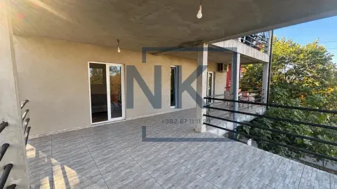 Large covered terrace with ceramic tiles and a metal railing. - image 6