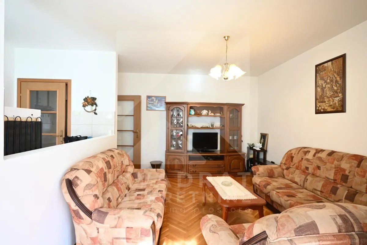 Living room with a sofa set and wooden furniture.