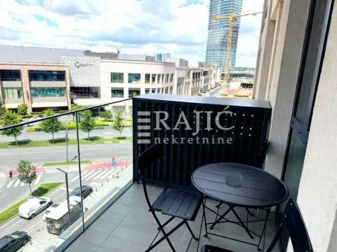 Furnished balcony with a table and chairs and a city view. - image 9