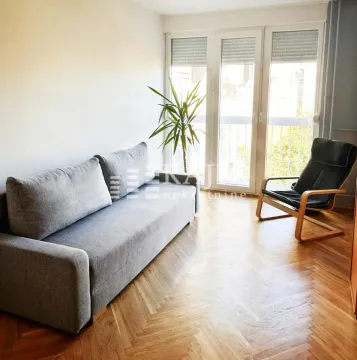 Living room with a sofa, armchair and parquet flooring. - image 8