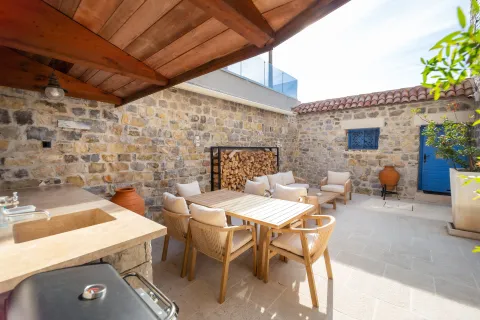 Paved courtyard with outdoor seating and a fireplace. - image 19