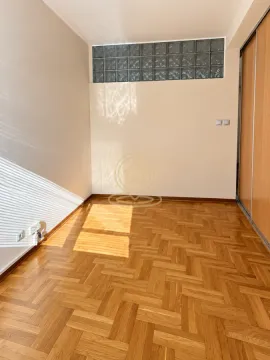 Empty room with parquet flooring and a built-in wardrobe. - image 4