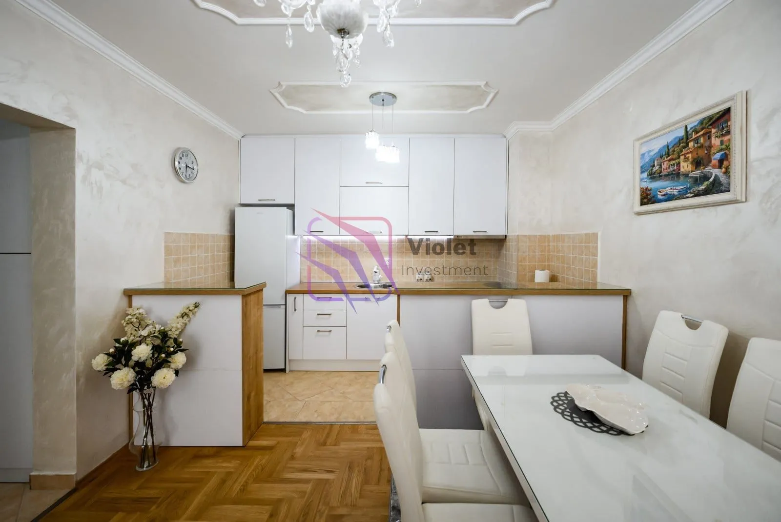 Small kitchen with a dining area and white cabinets.