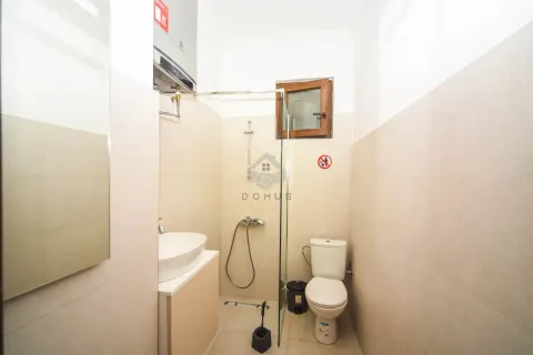 Bathroom equipped with a sink, toilet, and a glass-partitioned shower cabin. - image 5