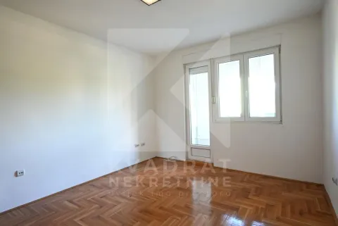 Empty room with hardwood parquet flooring and balcony access. - image 18
