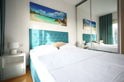 Furnished bedroom with a double bed, nightstands, and a large mirrored wardrobe. - image 14