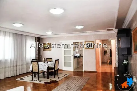 Living room with a dining area and parquet flooring. - image 4