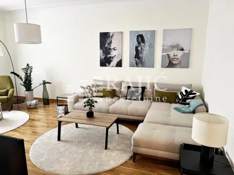Spacious living room with a sectional sofa, coffee table, and decorative paintings on the wall. - image 17