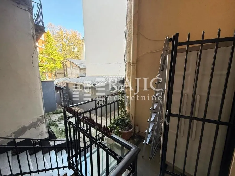 View of the exterior property area with stairs and metal railing.