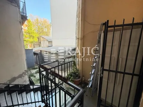 View of the exterior property area with stairs and metal railing. - image 8
