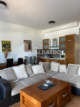 Living room with a sofa set, dining area, and kitchen in the background. - image 2
