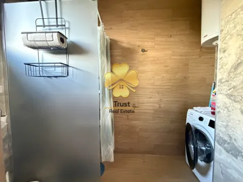 Smaller bathroom with a shower cabin and washing machine. - image 13