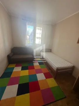 Children's bedroom with a bed, sofa and colorful rug. - image 4
