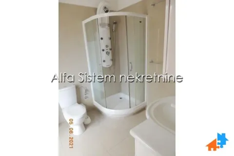 Bathroom equipped with a shower cabin, washbasin, and toilet. - image 16