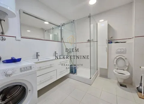 Modernly equipped bathroom with a shower cabin and washing machine. - image 4