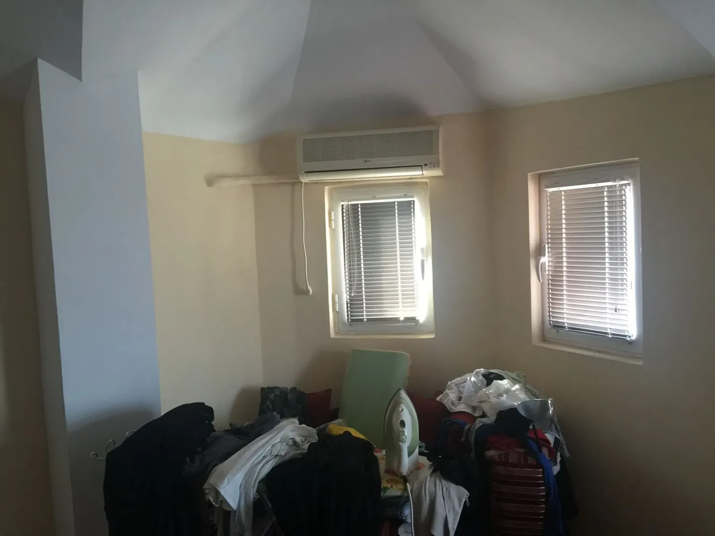 A room with windows and an air conditioner.