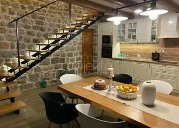 Dining area with a rustic-style kitchen and stairs. - image 10