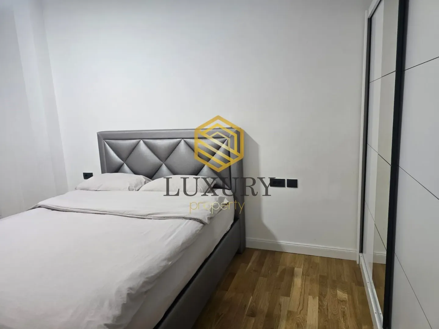 Modern bedroom with a double bed and wardrobe.
