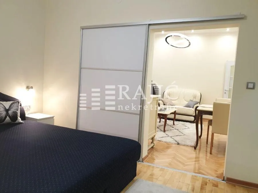 Bedroom overlooking the living room through sliding doors.