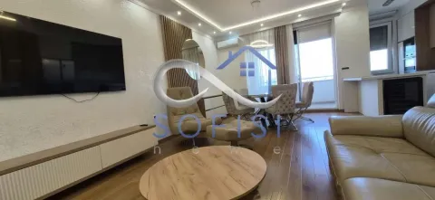 Spacious living room with a sofa, TV, and dining area. - image 17