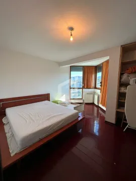 Bedroom with a double bed, wooden flooring and windows with a view. - image 5