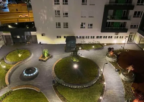Night view from above of the landscaped courtyard and building entrance with lighting. - image 9
