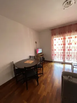 Bright living room with a dining table and terrace access. - image 5