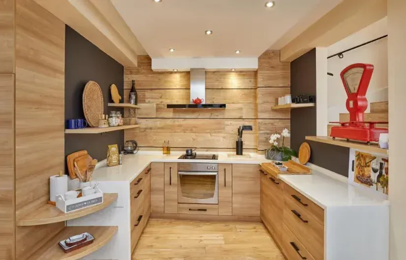 Modern kitchen with wooden cabinetry, built-in appliances, and a horseshoe-shaped countertop.