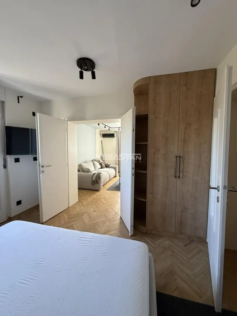 View from the bedroom towards the living room with open doors.