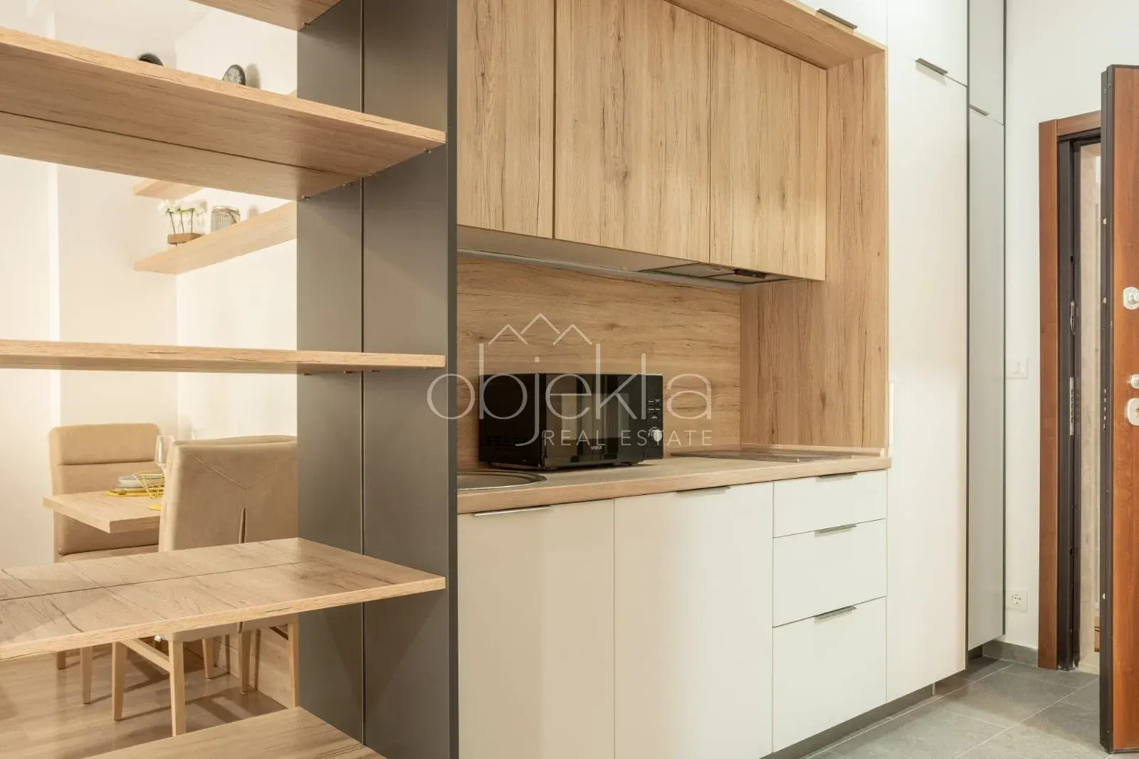 Modern kitchen with wooden elements and built-in appliances.
