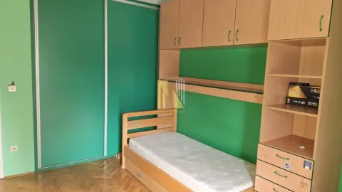 Children's bedroom with a wooden bed and built-in closets. - image 5