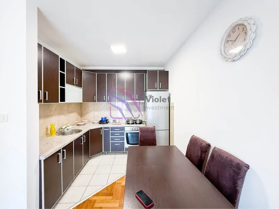 Kitchen with dark cabinetry and a dining table.