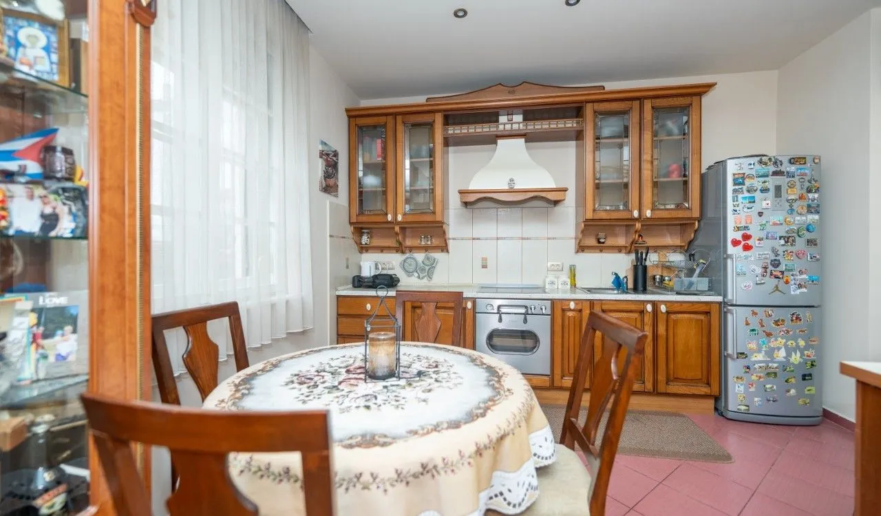 Traditional kitchen with wooden cabinetry and a dining table.