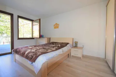Bright bedroom with a double bed, nightstand, and wardrobe. - image 7