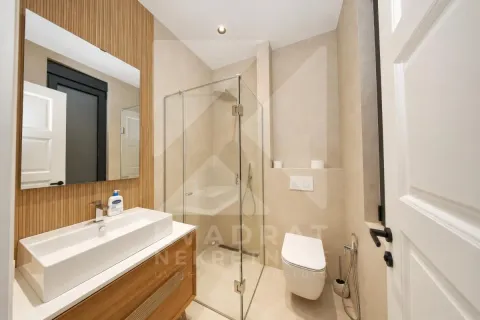 Modern bathroom with a walk-in shower, washbasin, and built-in sanitaryware. - image 17