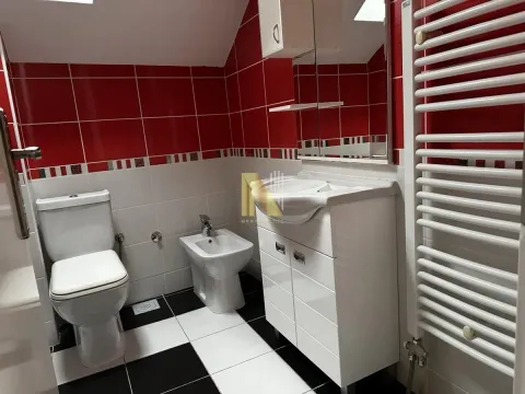 Modernly equipped bathroom with sanitary ware and red and white tiles. - image 10