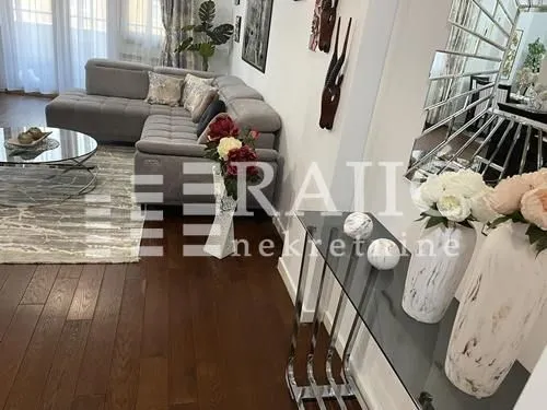 Living room with a sofa and dining area.