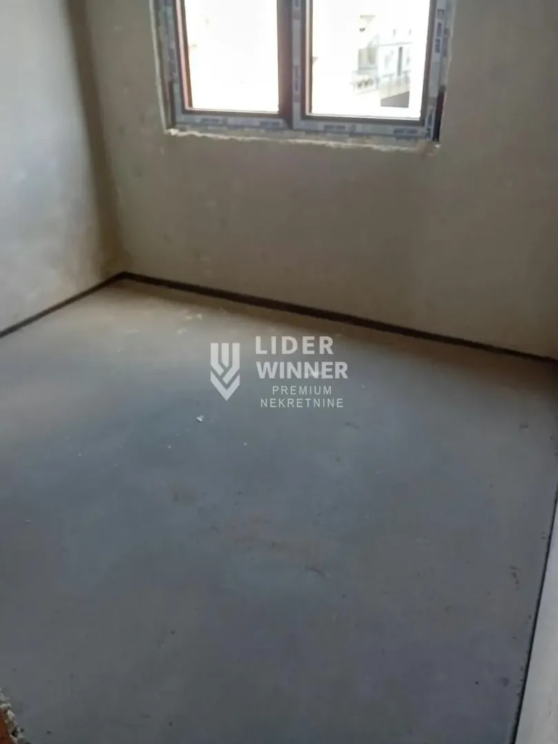View of an empty room under construction with a window.