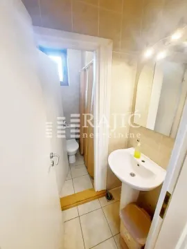 Small bathroom with a sink, mirror, and toilet. - image 7