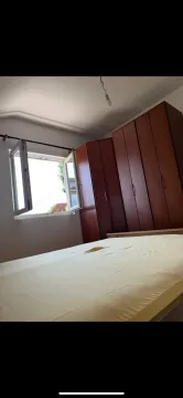 Furnished bedroom with a double bed and a wardrobe. - image 8