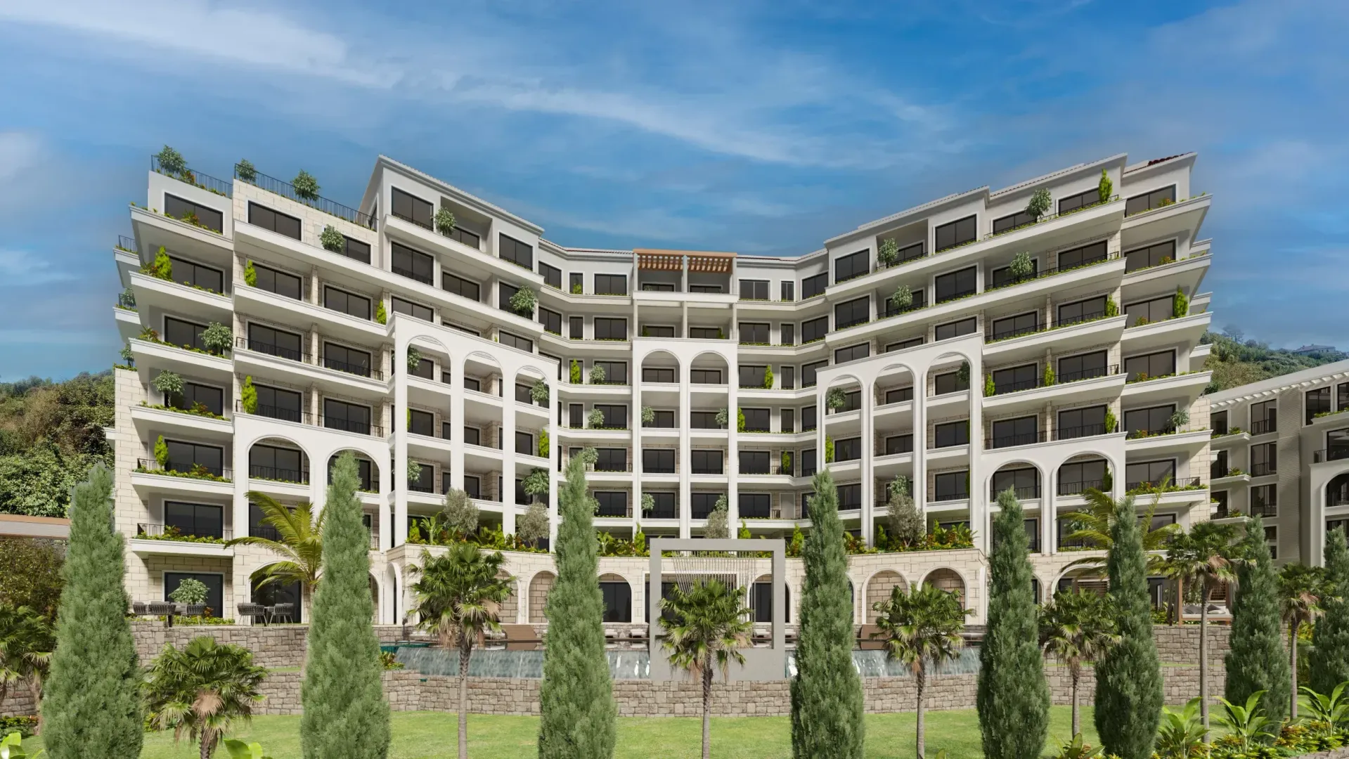 View of the exterior of a modern residential building with terraces and a landscaped courtyard.