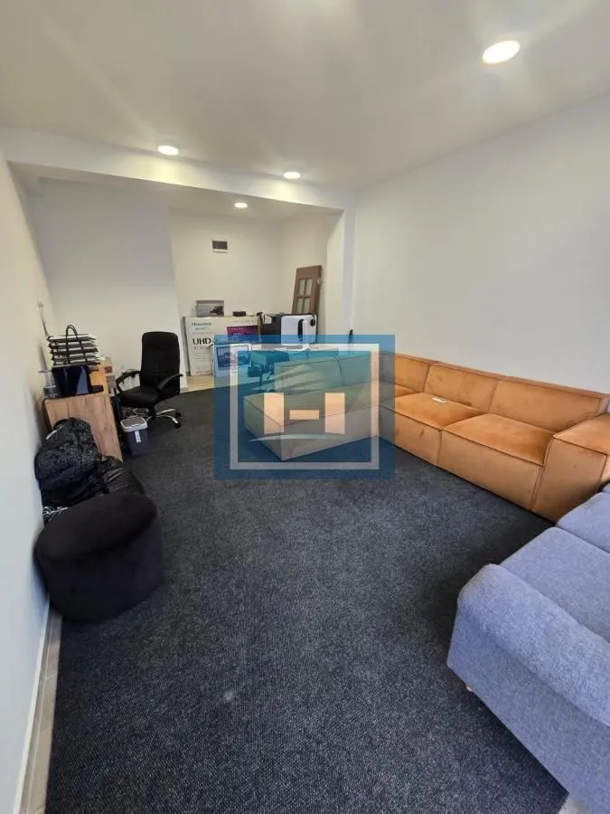 Living room with sofas and carpet.