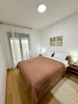 Furnished bedroom with a double bed, nightstands, and access to the terrace. - image 8