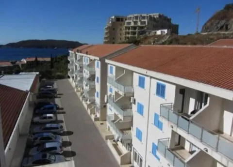 Elevated view of the exterior of a residential building and parking lot. - image 2